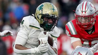 Bishop Feehans Xavier Baker bounces it to the outside for some of his 54 rushing yards he got during first quarter action of