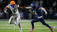 Battle Ground's Maddox Porter (3) holds out his arm against Grace's Campbell Johnson (7) during a TSSAA high school football