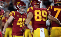  USC Denis Lynch is congratulated by teammates after completing a field goal against Fresno State at the Coliseum in Los Angeles. on Saturday night, Sep. 17, 2022. (Luis Sinco / Los Angeles Times)