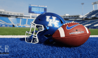 Football in front of a Kentucky helmer at Kroger Field