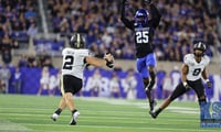 Vanderbilt quarterback Diego Pavia looks to throw the ball with Kentucky defender Jordan Lovett in pursuit - Dr. Michael Huang, Kentucky Sports Radio