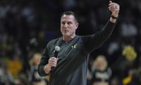 Wake Forest football coach Jake Dickert talks to fans.