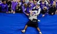 Brownsburg Bulldogs football player leaps into the stands after an Indiana high school football game.