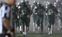 Dutch Fork players enter the field before a South Carolina high school football game.