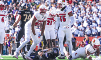 Louisville football's A.J. Green (98) and Antonio Watts (35) celebrate a tackle for loss in the 35-34 2025 Sun Bowl win over Washington.