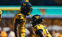 West Virginia defensive back Jordan Scruggs celebrates the pass breakup