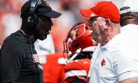 Louisville football head coach Jeff Brohm, right, talks with defense coordinator Ron English as the Cards take on Bowling Green in football Saturday, Sept. 20, 2025, in Louisville, Kentucky