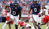 Oct 12, 2024; Charlottesville, Virginia, USA; Virginia Cavaliers running back Xavier Brown (0) carries the ball to score a touchdown against the Louisville Cardinals during the second half at Scott Stadium. Mandatory Credit: Amber Searls-Imagn Images