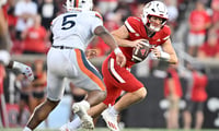 Oct 4, 2025; Louisville, Kentucky, USA; Louisville Cardinals quarterback Miller Moss (7) scrambles under the pressure of Virginia Cavaliers linebacker Kam Robinson (5) during the second half at L&N Federal Credit Union Stadium. Virginia defeated Louisville 30-27. Mandatory Credit: Jamie Rhodes-Imagn Images