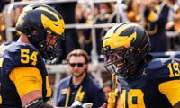 Michigan Wolverines football offensive lineman Andrew Sprague and quarterback Bryce Underwood celebrate after a touchdown in a 63-3 win over Central Michigan. (Photo by Junfu Han / USA TODAY NETWORK via Imagn Images)
