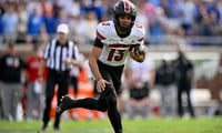 Nov 22, 2025; Dallas, Texas, USA; Louisville Cardinals quarterback Deuce Adams (13) runs with the ball against the SMU Mustangs during the first half at Gerald J. Ford Stadium. Mandatory Credit: Jerome Miron-Imagn Images