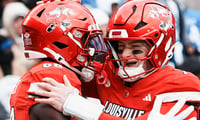 Louisville Cardinals tight end Jaleel Skinner (88) hugs Louisville Cardinals quarterback Miller Moss (7) after scoring a touchdown pass in the second half as the Cards dominated Kentucky 41-0 Saturday, November 29, 2025 in Louisville, Kentucky at L&N Federal Credit Union Stadium.