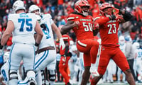 Wesley Bailey, Clev Lubin and Louisville celebrate sack in 41-0 win over Kentucky.