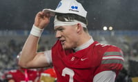 Baylor's Briggs Cherry (3) puts his championship hat on his head during the Division II-AAA championship game at Finley Stadium in Chattanooga, Tenn., on Dec. 4, 2025.