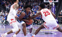 Nov 21, 2025; Salt Lake City, Utah, USA; BYU Cougars guard Robert Wright III (1) drives against Wisconsin Badgers guard Nick Boyd (2) and guard John Blackwell (25) during the second half at Delta Center. Mandatory Credit: Rob Gray-Imagn Images