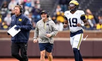 Michigan head coach Kyle Whittingham, center, offensive coordinator Jason Beck, left, and Michigan quarterback Bryce Underwood (19) run across the field during the spring game at Michigan Stadium in Ann Arbor on Saturday, April 18, 2026. (Junfu Han/Detroit Free Press)