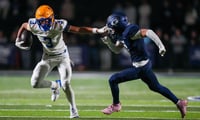 Battle Ground's Maddox Porter (3) holds out his arm against Grace's Campbell Johnson (7) during a TSSAA high school football