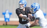 Memphis Marcus Stokes (2) hands Jaylin Carter (6) the ball in a drill during practice at the Billy J. Murphy Athletic Complex