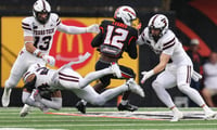 Oregon State's Jesse Legree (12) attempts to evade tackles from Texas Tech defenders during an NCAA football game at Reser