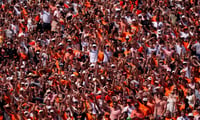 Oklahoma State fans cheer in the first half of the college football game between the Oklahoma State Cowboys and the Oregon Ducks