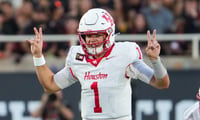 Houston's Conner Weigman gestures at the line of scrimmage against Texas Tech during a Big 12 Conference football game, Friday,