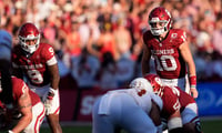 Oklahoma's John Mateer (10) lines up in the second half of the Red River Rivalry college football game between the University of