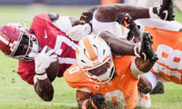 Alabama running back Traeíshawn Brown (17) is tackled by Tennessee linebacker Amare Campbell (0) and Tennessee defensive lineman Tyree Weathersby (18) during a game between Tennessee and Alabama in Neyland Stadium in Knoxville, Tenn., Oct. 17, 2026.