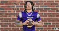 USC Trojans Class of 2025 wide receiver commitment Corey Simms poses in his Christian Brothers College jersey holding a football