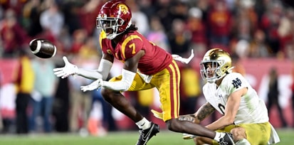 Defensive back Calen Bullock #7 of the USC Trojans intercepts a pass intended for wide receiver Braden Lenzy #0 of the Notre Dame Fighting Irish in the second half of a NCAA football game at the Los Angeles Memorial Coliseum in Los Angeles on Saturday, No