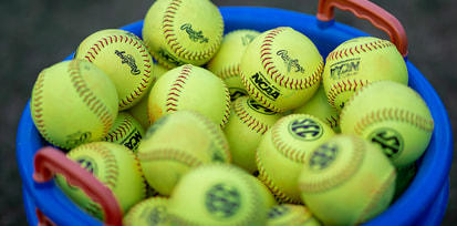 SEC softballs in a bucket