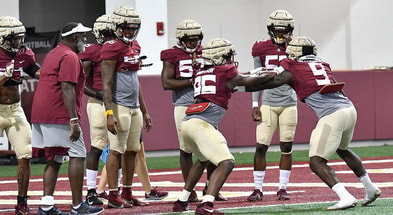 Florida State defensive line coach Odell Haggins working with his players.
