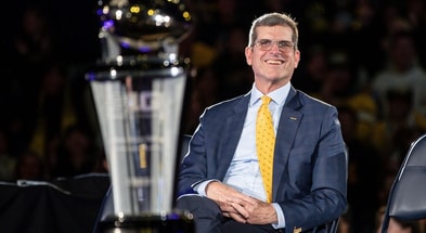 Jim Harbaugh looks on during Michigan's national championship celebration.