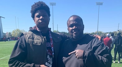 2026 OL Zyon Guiles out of Carvers Bay (SC) is pictured with Gamecocks OL coach Lonnie Teasley during a visit to South Carolina (Photo: Zyon Guiles | X)