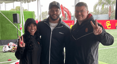 Former Los Angeles Rams defensive lineman Aaron Donald visits a USC practice and poses with Senior Associate Athletic Director Dave Emerick