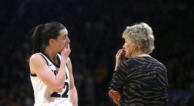 Caitlin Clark (22) talks to coach Lisa Bluder while playing Holy Cross in a first-round NCAA Tournament game. (Julia Hansen/Iowa City Press-Citizen)
