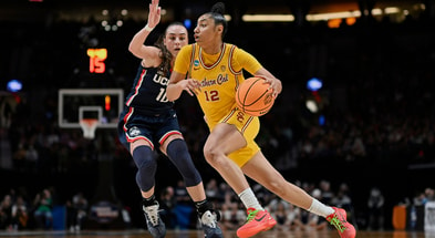 USC Trojans guard JuJu Watkins (12) drives to the basket during the second half against UConn Huskies guard Nika Muhl (10) in the finals of the Portland Regional of the NCAA Tournament at the Moda Center