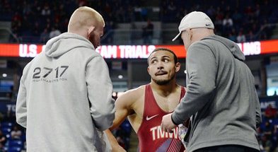 Coaches Bo Nickal, left, and Cael Sanderson, right, talk with Aaron Brooks during his first match at the U.S. Olympic Wrestling Trials at Penn State's Bryce Jordan Center on Friday, April 19, 2024. (Andy Mason/Herald-Mail / USA TODAY NETWORK)