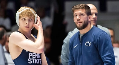 Penn State wrestling assistant coach Jimmy Kennedy talks with freshman Braeden Davis (125 pounds) during the Nittany Lions' Big Ten dual meet against Ohio State. (Dan Rainville / USA TODAY NETWORK)