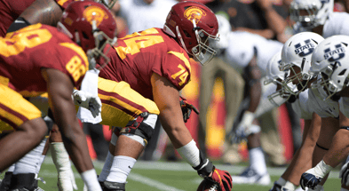 General view of the line of scrimmage as USC Trojans center Nico Falah (74) snaps the ball against the Utah State Aggies during a NCAA football game at Los Angeles Memorial Coliseum