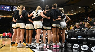 The Hawkeyes huddle during a timeout against Indiana. (Photo by Dennis Scheidt)