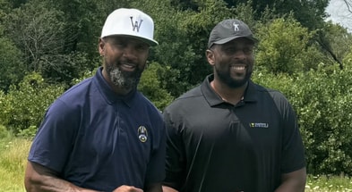 Michigan Wolverines football head coach Sherrone Moore with 1997 Heisman Trophy winner and Pro Football Hall of Fame inductee Charles Woodson. (Photo by Champions Circle)