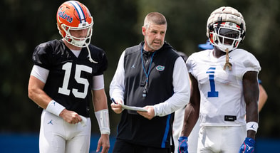 Florida Gators head coach Billy Napier talks with Florida Gators quarterback Graham Mertz (15) and Florida Gators running back Montrell Johnson Jr. (1) during fall football practice at Heavener Football Complex at the University of Florida in Gainesville, FL on Thursday, August 1, 2024. [Matt Pendleton/Gainesville Sun]