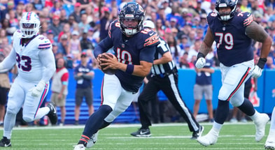 Chicago Bears quarterback Caleb Williams (18) runs with the ball against the Buffalo Bills during the first half at Highmark Stadium