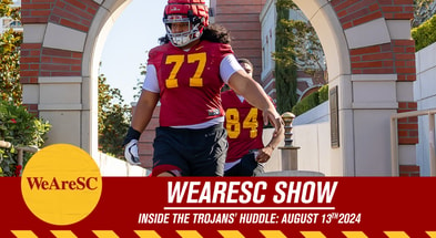 Article feature image for Inside the Trojans' Huddle, showing USC offensive lineman Alani Noa walking out to a fall camp practice.