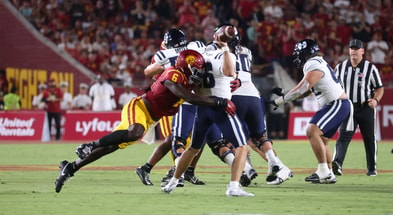 USC Trojans defensive end Anthony Lucas hits Utah State quarterback Bryson Barnes as he's attempting to throw a pass