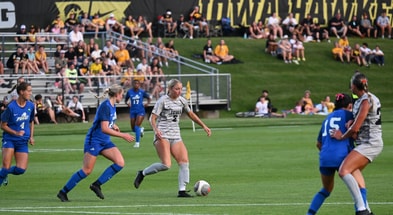 Iowa forward Berit Parten dribbles the ball against the FGCU defense. (Photo by Dennis Scheidt)