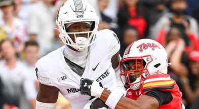 Michigan State Spartans wide receiver Jaron Glover (4) catches a pass for a touchdown as Maryland Terrapins defensive back Jalen Huskey (22) defends during the second quarter at SECU Stadium. - Tommy Gilligan, USA TODAY Sports