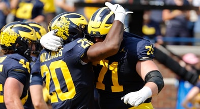 Sep 14, 2024; Ann Arbor, Michigan, USA; Michigan Wolverines running back Kalel Mullings (20) celebrates with offensive lineman Evan Link (71) after running for a touchdown against the Arkansas State Red Wolves in first half at Michigan Stadium. Mandatory Credit: Rick Osentoski-Imagn Images