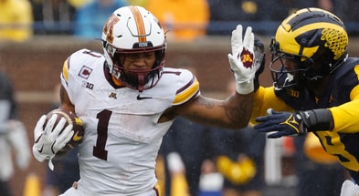 MinnesotaMinnesota Golden Gophers running back Darius Taylor (1) rushes chased by Michigan Wolverines defensive end Derrick Moore (8) in the first half at Michigan Stadium