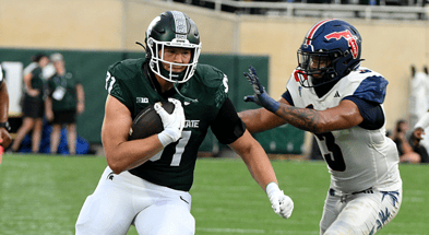 Michigan State Spartans tight end Michael Masunas (81) gets a first down against Florida Atlantic Owls linebacker Eddie Williams (3) in the first quarter at Spartan Stadium. - Dale Young, USA TODAY Sports